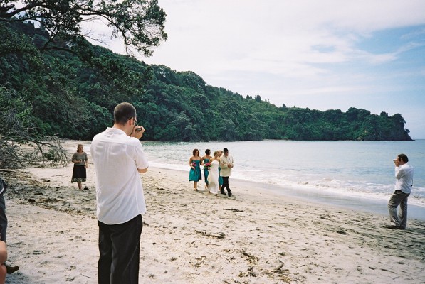 James playing the mouth organ as Vicky comes up the beach