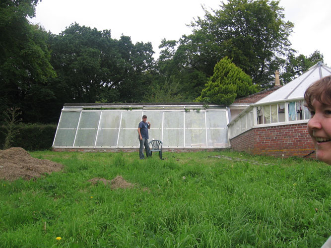 Frankie standing in front of the conservatory, waiting for the group picture.